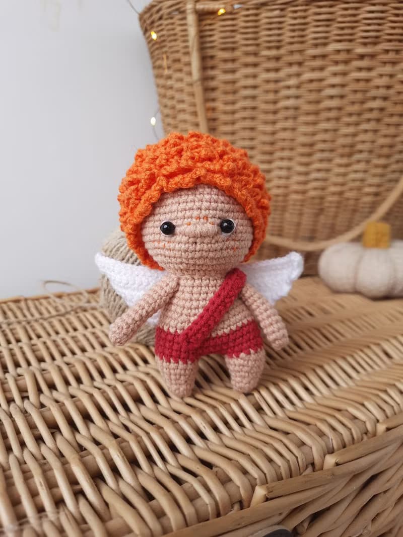 Little angel with red hair gift to parents on the birth of baby. Valentine's Day