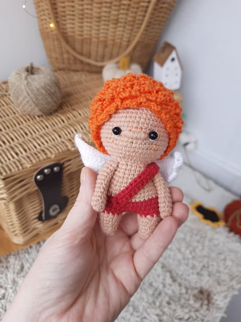 Little angel with red hair gift to parents on the birth of baby. Valentine's Day