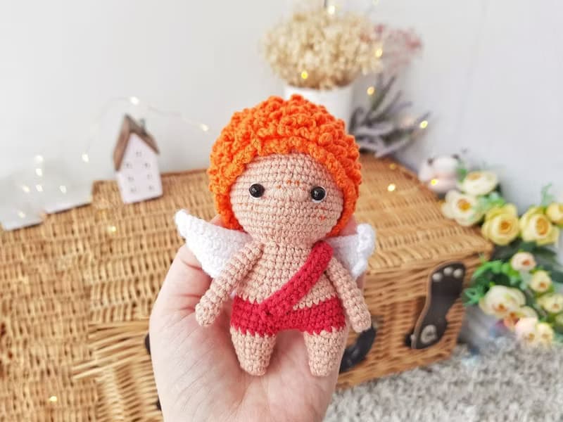 Little angel with red hair gift to parents on the birth of baby. Valentine's Day