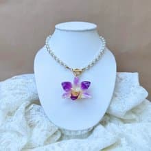Purple Dendrobium with pearl and gold bead necklace