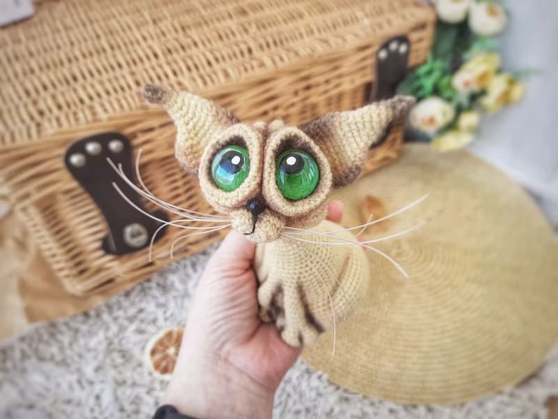 Siamese cat toy sculpture . Knitting sitting realistic pet replica. Cat toy