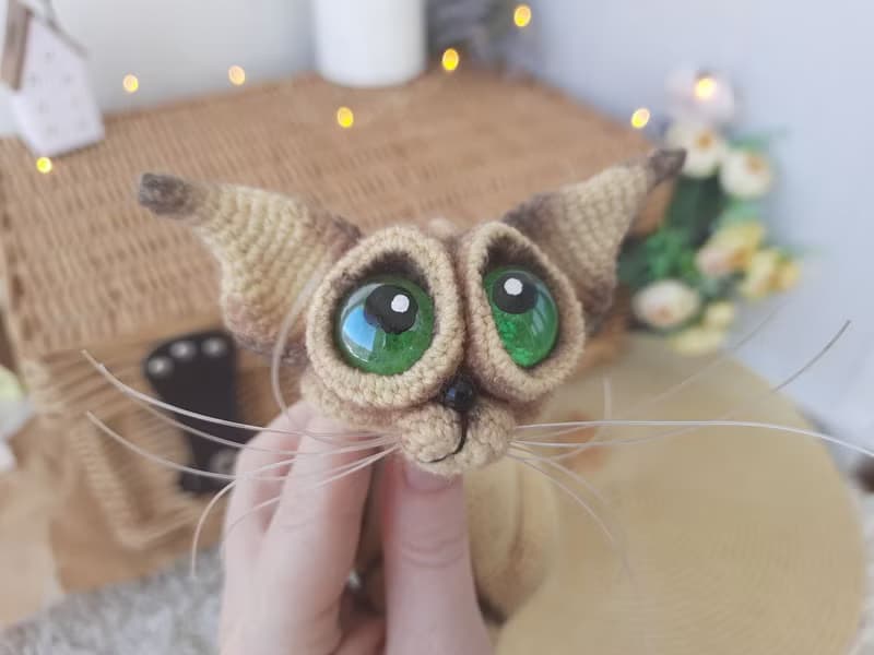 Siamese cat toy sculpture . Knitting sitting realistic pet replica. Cat toy