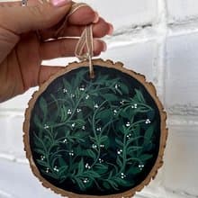 Delicate Floral Ornament on Wooden Slice