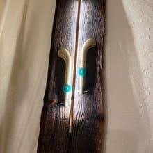 Wall sconce of antiques violin bow and brass pedals from the piano
