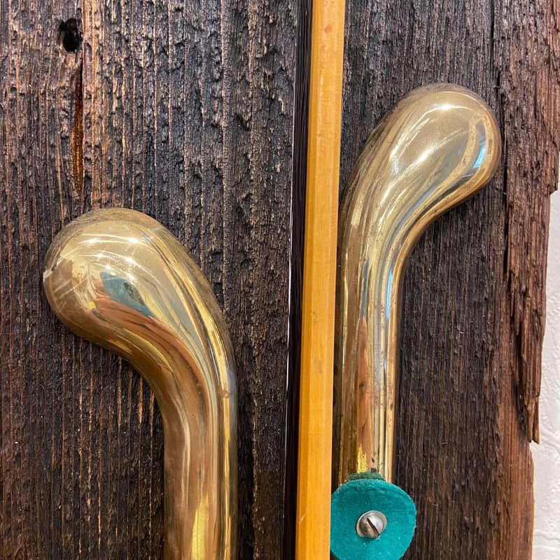 Wall sconce of antiques violin bow and brass pedals from the piano