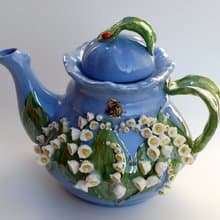 Beautiful blue teapot. Decor lilies of the valley and bees. Porcelain art.