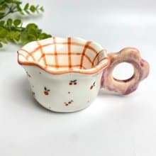 Lovely handmade white ceramic mug with red checkered pattern