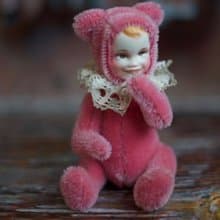 Raspberry teddy doll created with pink mohair with hand painted face