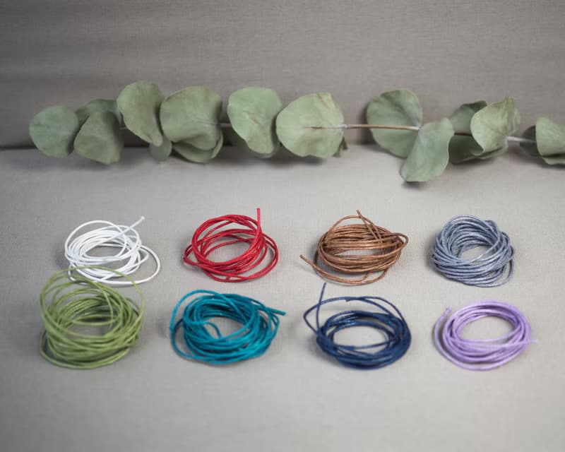 Glass bottle of gems for creativity boost, waxed cord, 12 raw crystals