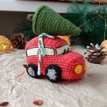 Red car with Christmas tree for gift. Holiday toy home decor. New year red car
