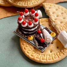 Miniature chocolate cake set with cherries