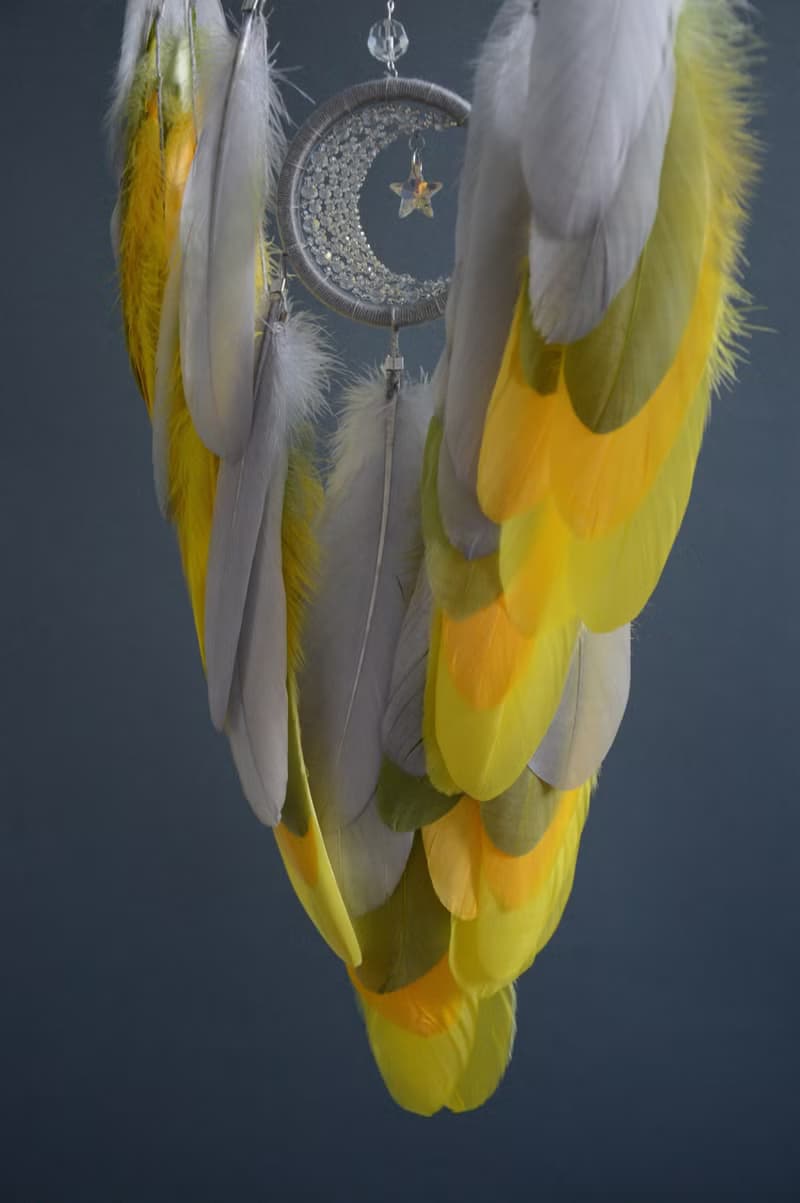 Handcrafted Dream Catcher with Sparkling Crystals and Vibrant Yellow Feathers