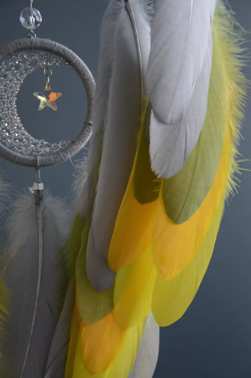 Handcrafted Dream Catcher with Sparkling Crystals and Vibrant Yellow Feathers