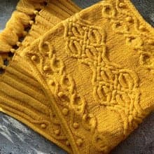 Handmade mustard scarf with beautiful pattern and tassels knitted from merino