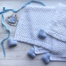 Hand knit white blanket with blue, or pink hearts toys for baby. Baptism blanket