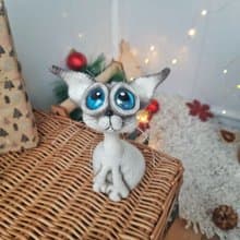 Siamese cat toy sculpture . Knitting sitting realistic pet replica. Cat toy