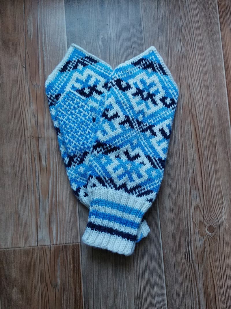 Women's and men's hand-knitted wool mittens are very warm with a pattern