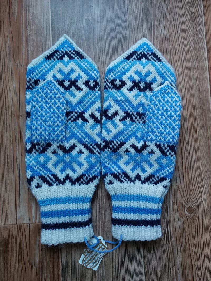 Women's and men's hand-knitted wool mittens are very warm with a pattern