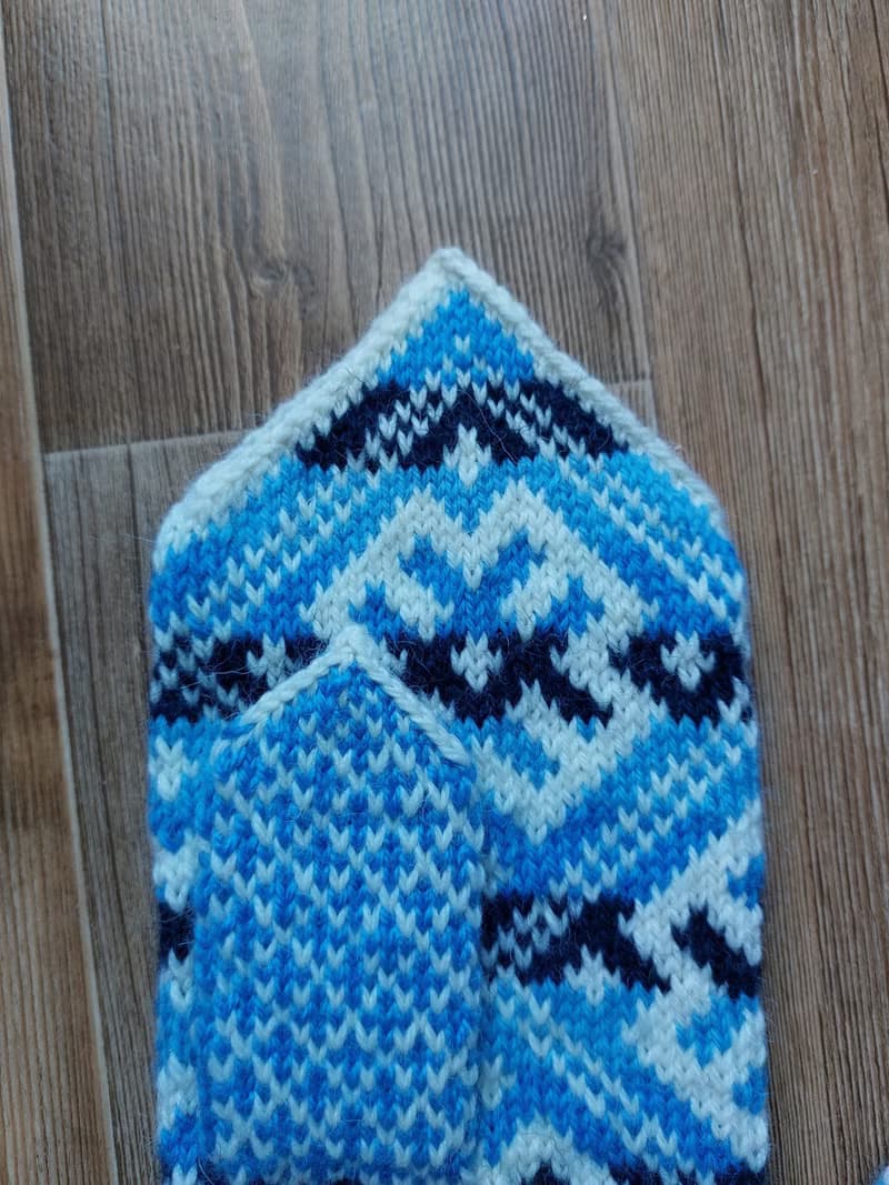 Women's and men's hand-knitted wool mittens are very warm with a pattern