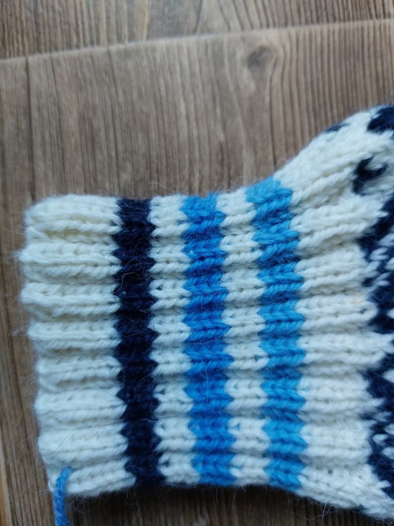 Women's and men's hand-knitted wool mittens are very warm with a pattern