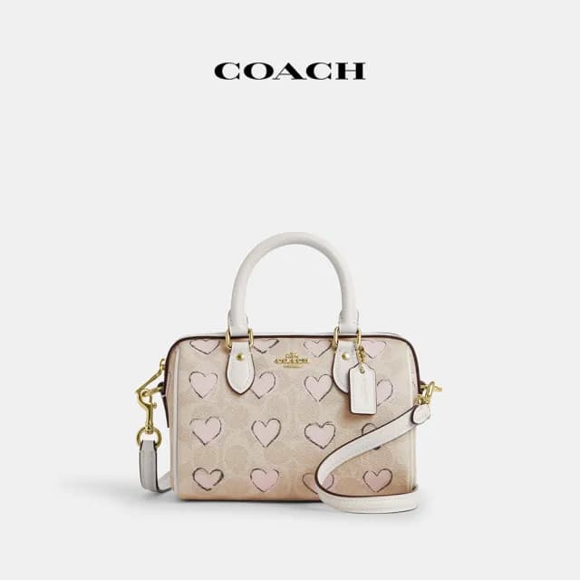 【COACH】蔻馳官方直營 ROWAN經典Logo愛心印花CITY迷你斜背手袋-IM/沙黃色 混合色(CBS69)