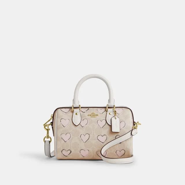 【COACH】蔻馳官方直營 ROWAN經典Logo愛心印花CITY迷你斜背手袋-IM/沙黃色 混合色(CBS69)
